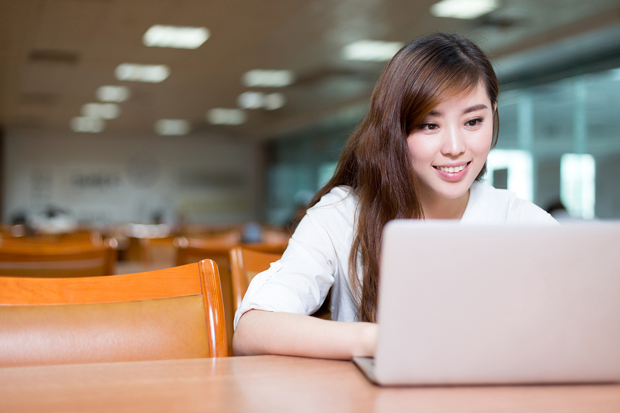 Asian-beautiful-female-student-study-in-library-with-laptop