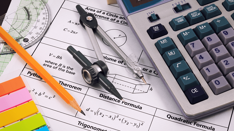 scientific-calculator-on-table-next-to-protractor-and-compass-with-pencil-and-sticky-notes-on-top-of-math-assignment-sheet